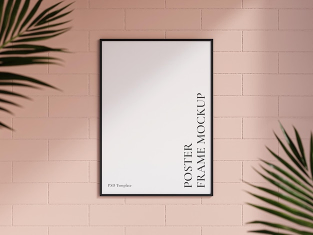 Schoon en minimalistisch vooraanzicht portret zwarte foto of poster frame mockup hangend aan de bakstenen muur met wazige plant 3D-rendering