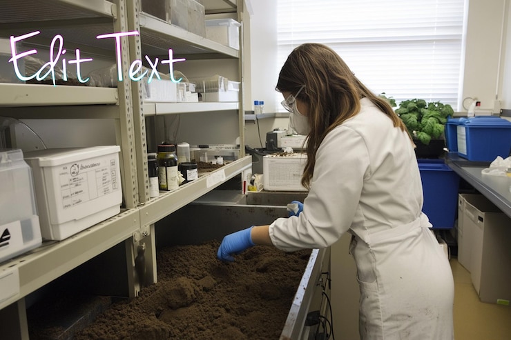 PSD scientist in lab coat examining soil sample in a lab