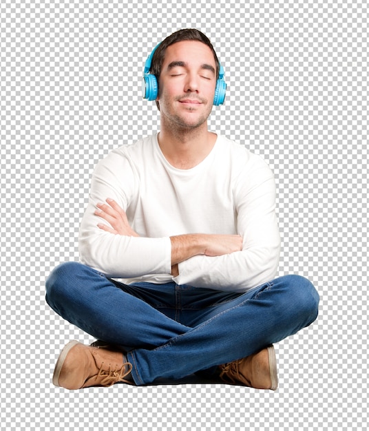 Seated happy young man using a headphones