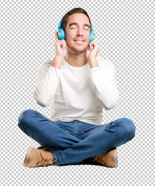 PSD seated happy young man using a headphones