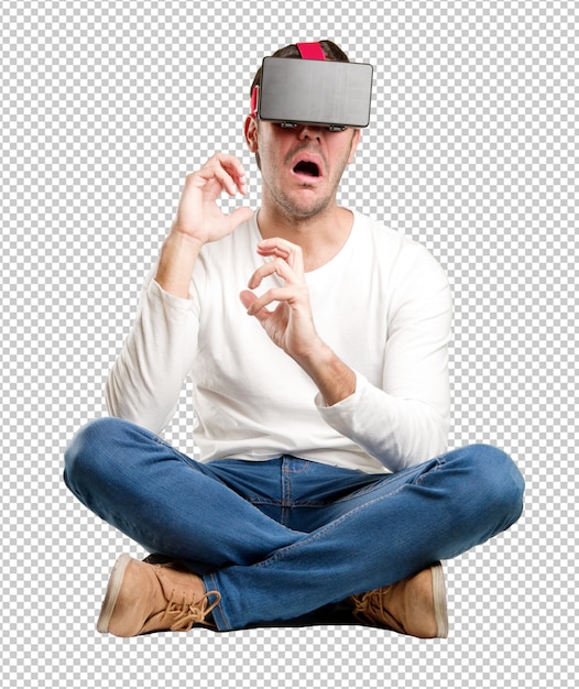 Сидящий молодой человек, используя очки виртуальной реальности