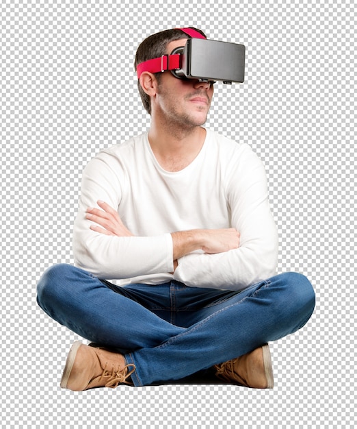 Seated young man using a virtual reality glasses