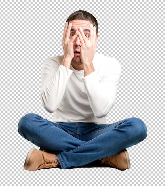 PSD seated young man with a fear gesture