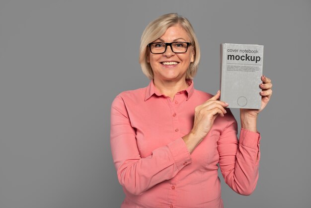 Senior person with book mockup