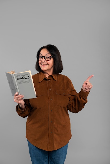 Senior person with book mockup