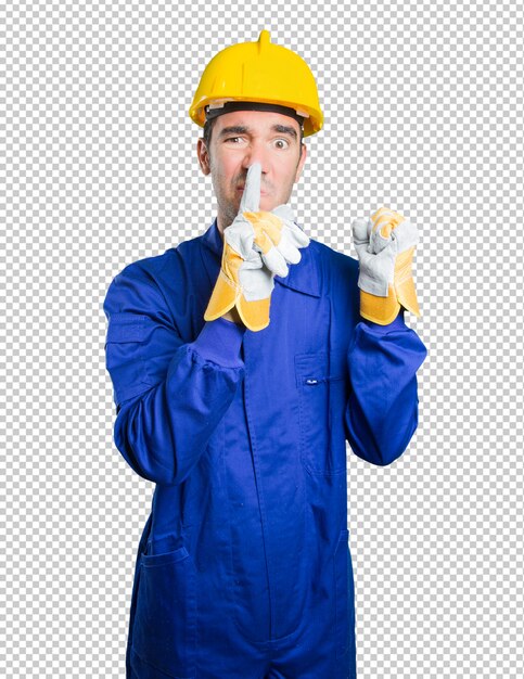 Serious workman with silence gesture on white background