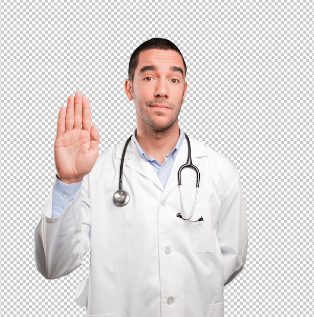 Serious young doctor showing his palm