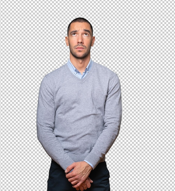 Serious young man looking against background