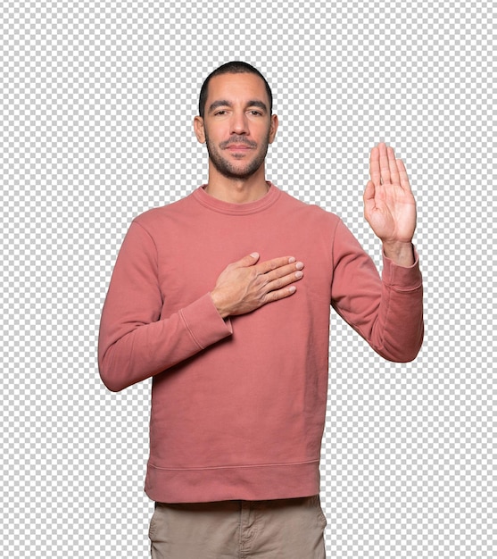 Serious young man with a gesture of oath