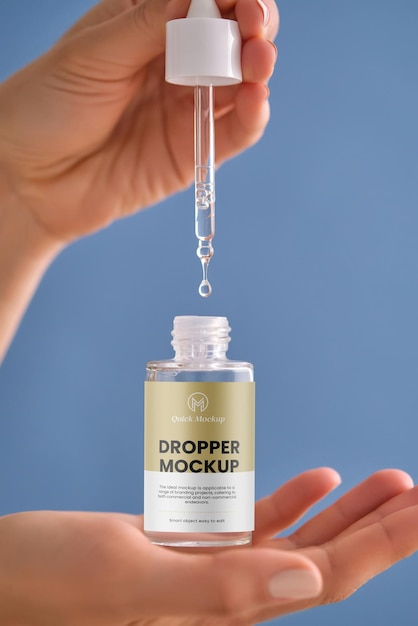 Serum with a pipette in female hands on a blue background