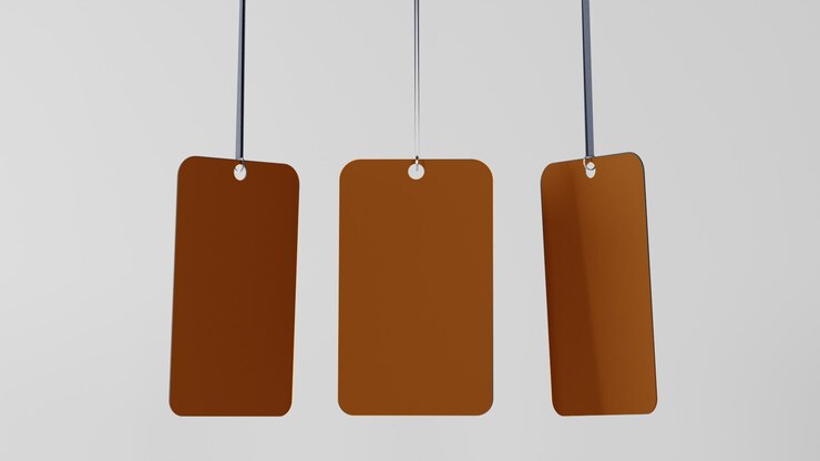PSD a set of orange tags hanging from a string editable mockup psd on white clean balckground