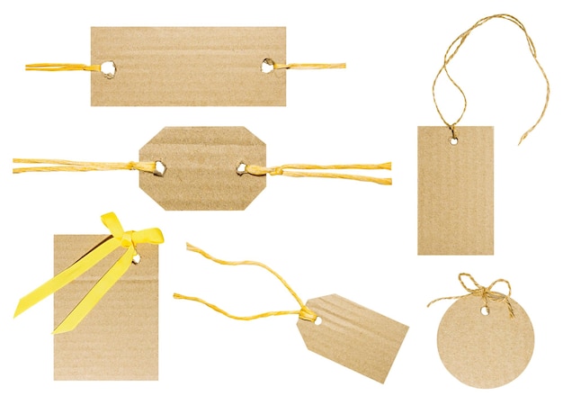 PSD setset of brown tags with cord or thread made of natural craft paper and cardboard different shapes and positions light colored thread cut out on a blank background