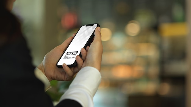 PSD side view of businesswoman using smartphone mockup