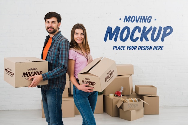 PSD side view of couple posing with moving boxes