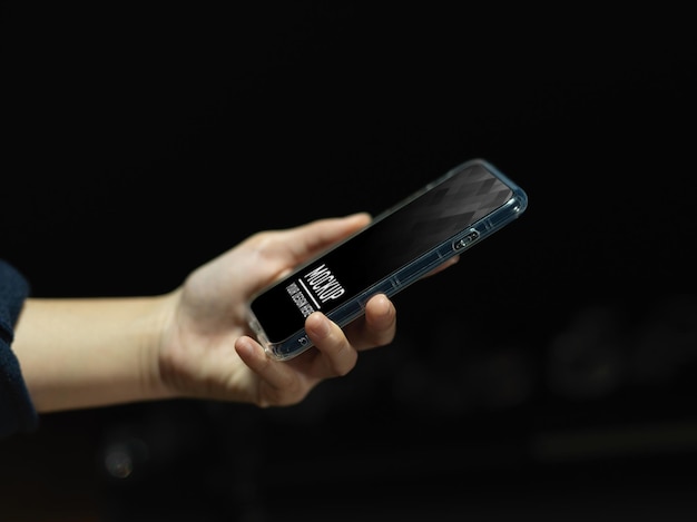 Side view of female hand holding smartphone mockup