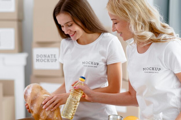 Side view of female volunteers preparing donations boxes