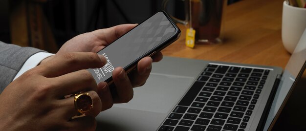 Side view of male hand using smartphone mockup