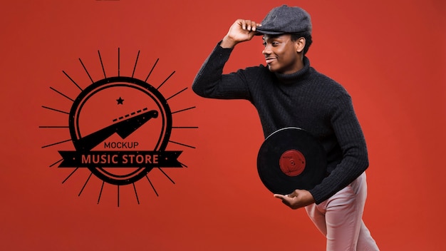 Side view of man holding vinyl disk for music store mock-up