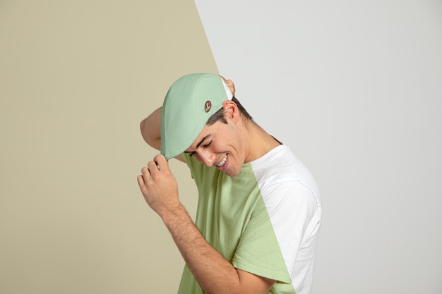 Side view of man touching his cap