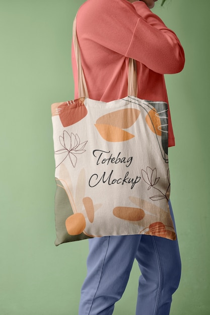 PSD side view of person holding tote bag mock-up