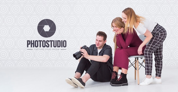 Side view of photographer with female clients