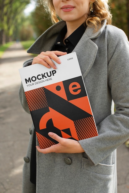 side view smiley woman holding book