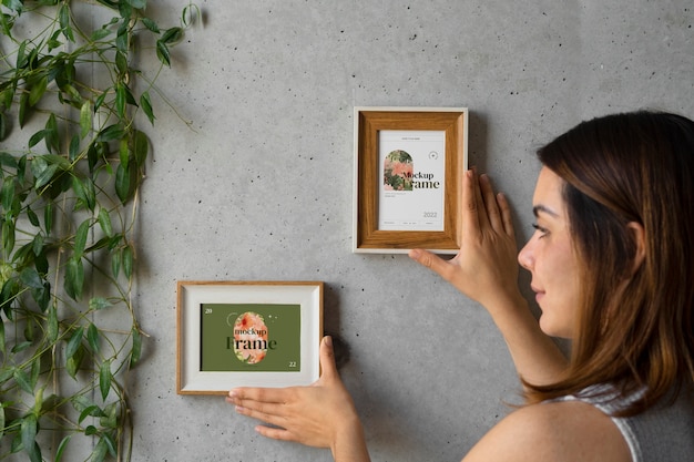 side view woman hanging a picture