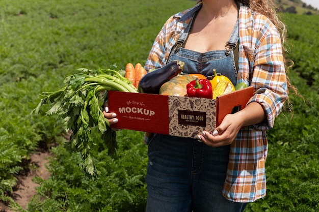 Side view  woman  holding a box in nature