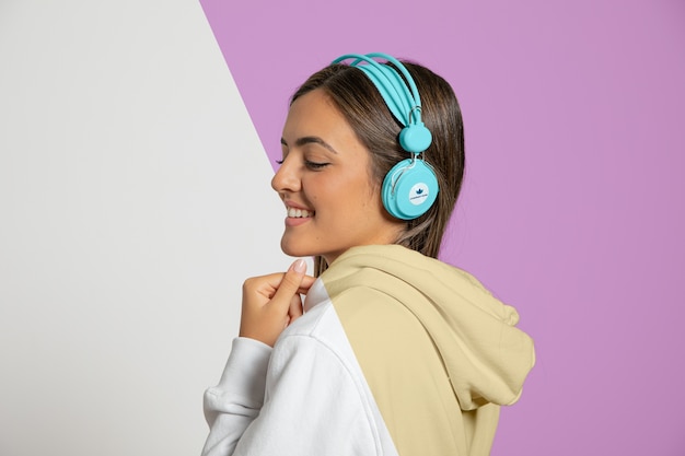 Side view of woman listening to music on headphones