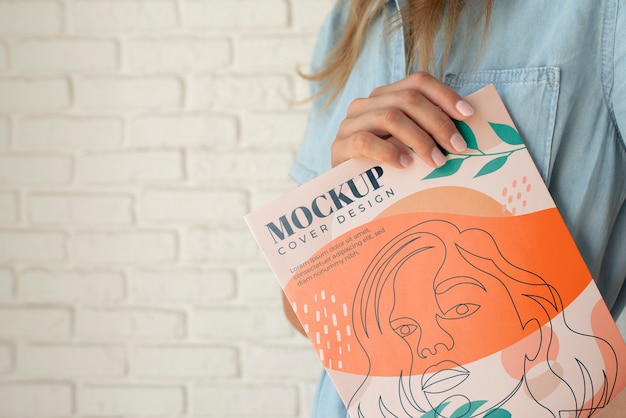 side view woman posing with magazine