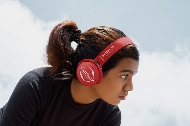 PSD side view woman wearing headphones outdoors