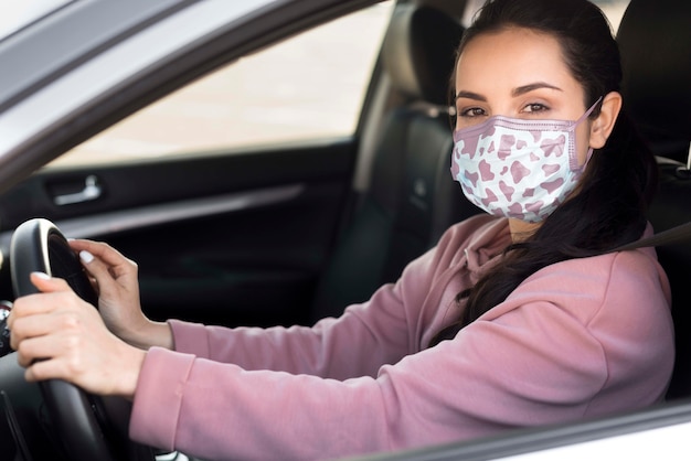 Side view woman with mask driving