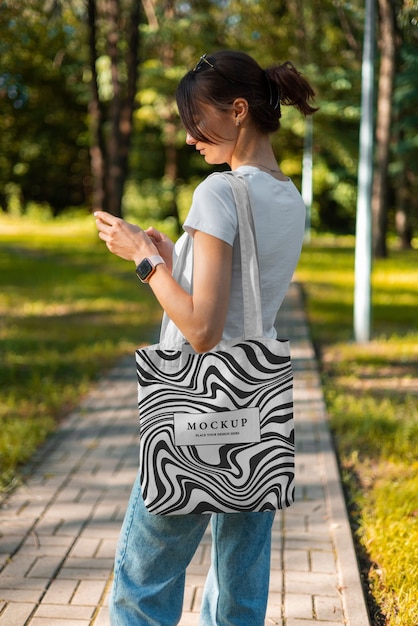 Side view woman with optical print tote bag