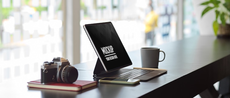 PSD side view of worktable office with mockup of digital tablet