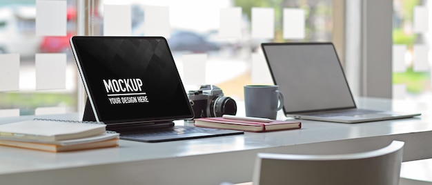 PSD side view of worktable office with mockup of digital tablet