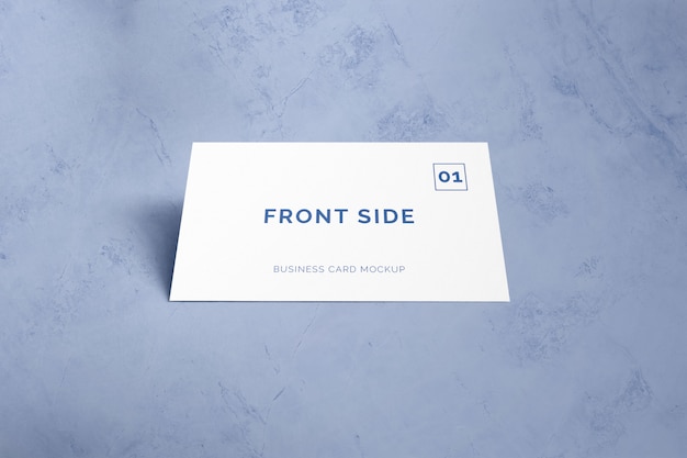 Single business card laying on marble mockup