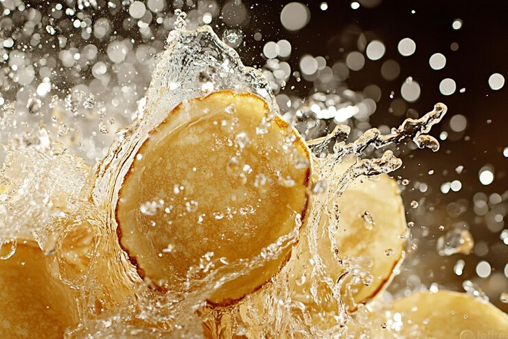 PSD sliced potatoes splashing in water