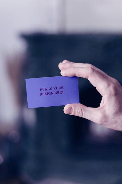 Small Purple Business Card PSD Mockup Held by a Man