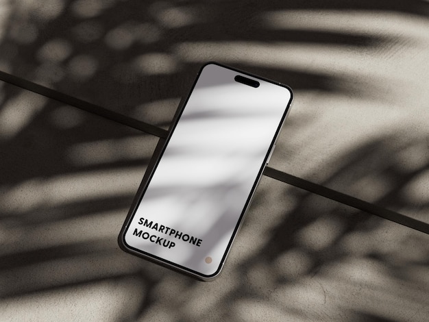 Smartphone on concrete with shadows