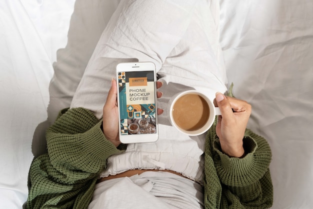 Smartphone device with cup of coffee