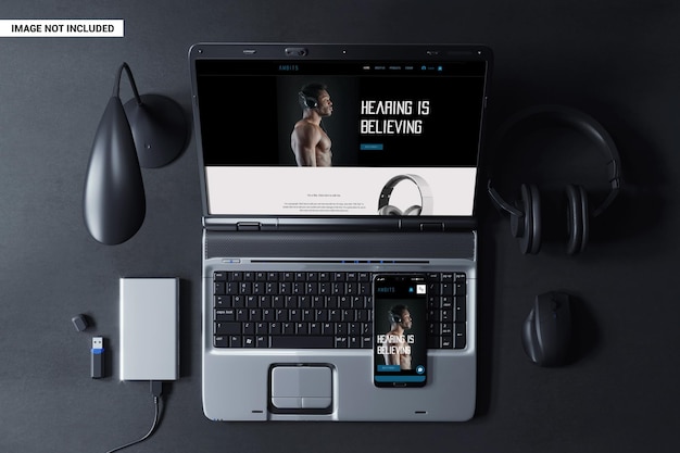 Smartphone and laptop at workplace top view scene mockup