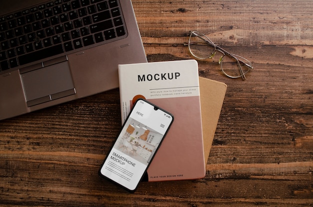 PSD smartphone and magazine book mock-up on wooden background