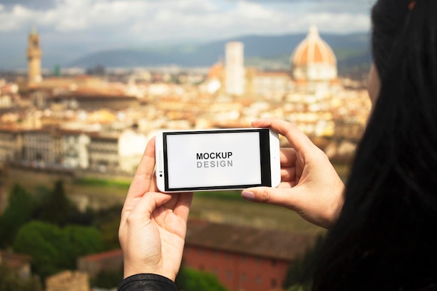 PSD smartphone mock-up with hands holding in italy