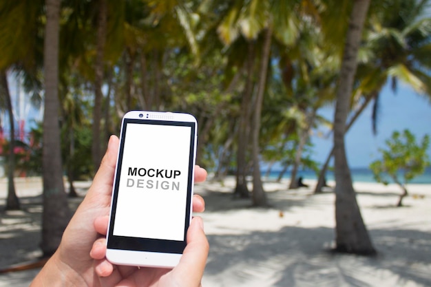 PSD smartphone mock-up with holding hands, beach, palm trees