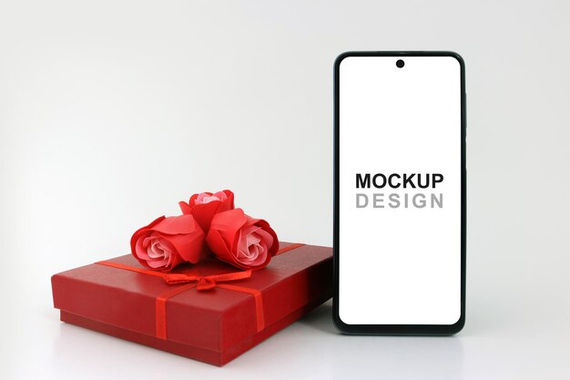 PSD smartphone mockup czerwone pudełko upominkowe i róże