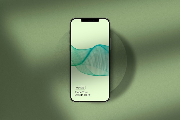 緑の表面上のスマートフォンのモックアップ