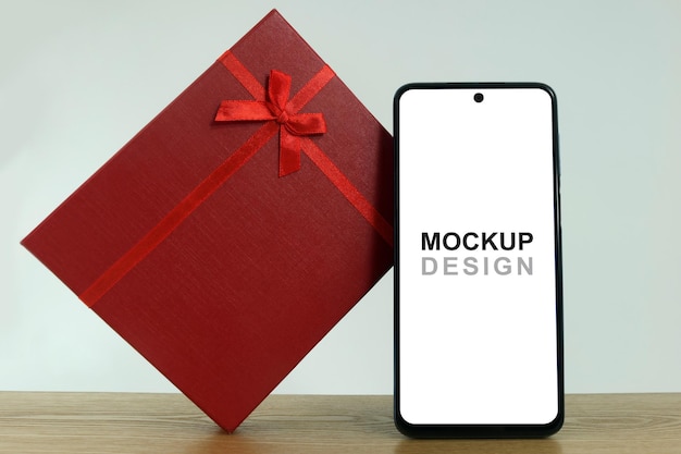 PSD smartphone mockup con confezione regalo rossa