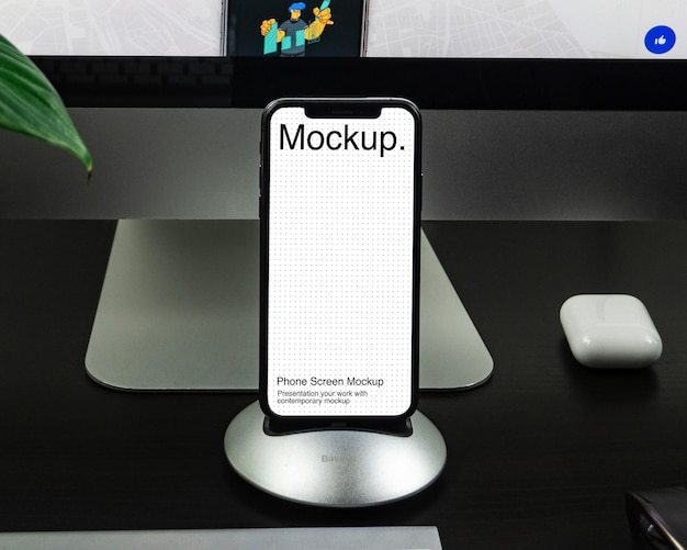 Smartphone with screen mockup on work table