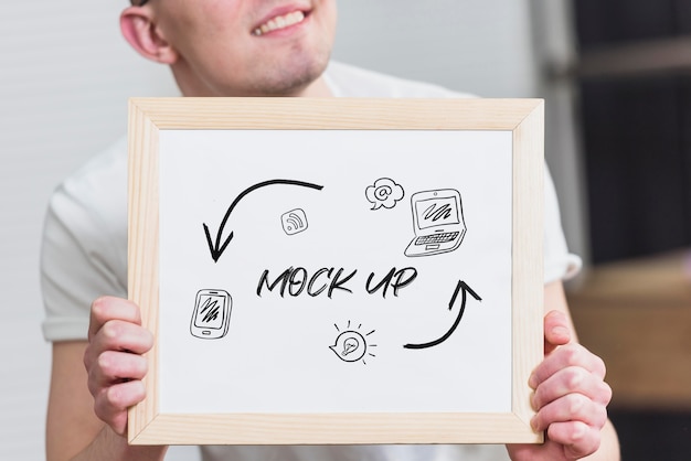 Smiley man holding mock-up frame