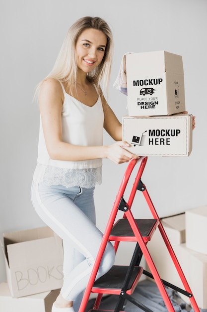 PSD smiley woman holding boxes